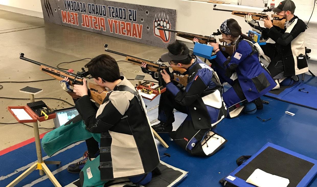 Five athletes of the rifle club prepare to compete in postal match.